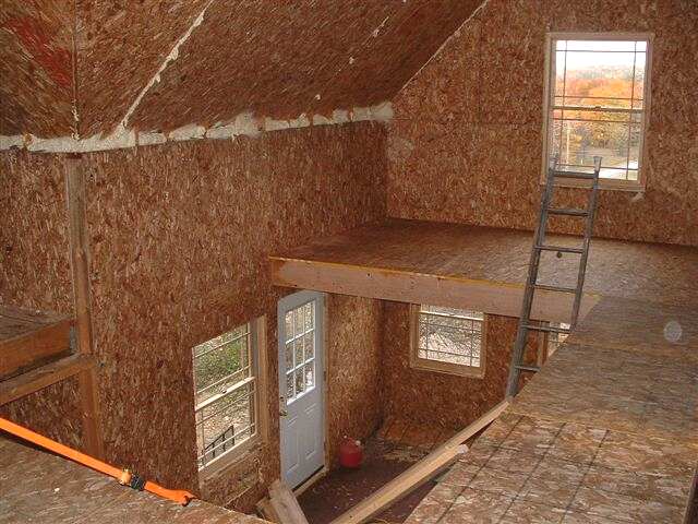 loft interior with the OSB faces of the SIP wall and roof panels still exposed