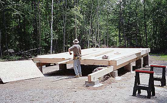 16x24 cabin framed with a shed roof and beams extended for a future deck