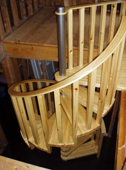 handbuilt wood spiral stair up to the loft