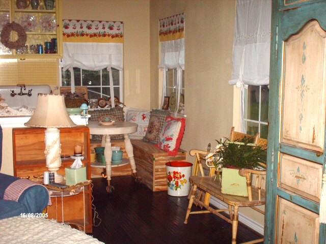 corner dining nook with windows on two sides and a painted cabinet