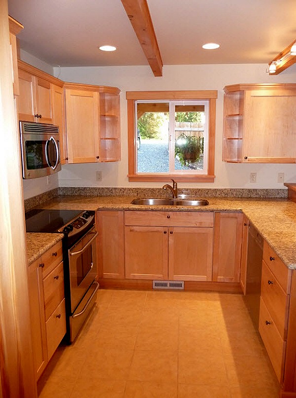 kitchen with maple cabinets, stone counters and a window over the sink