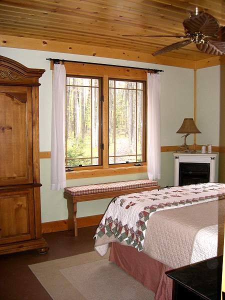 main floor bedroom with a wide pine baseboard, a chair rail and a bench under the window