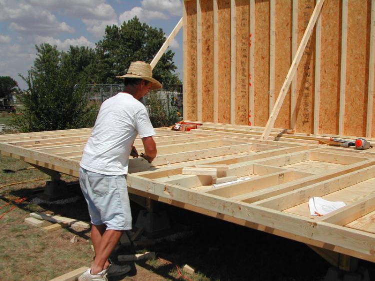 framing the wall studs on the floor deck of a 12x18 cabin