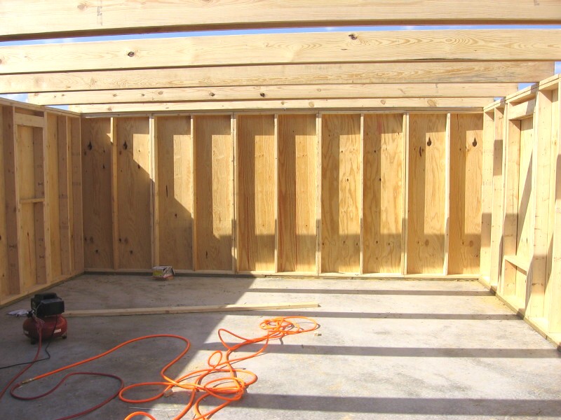 inside the framed shell, plywood faced wall panels with rafter ties overhead