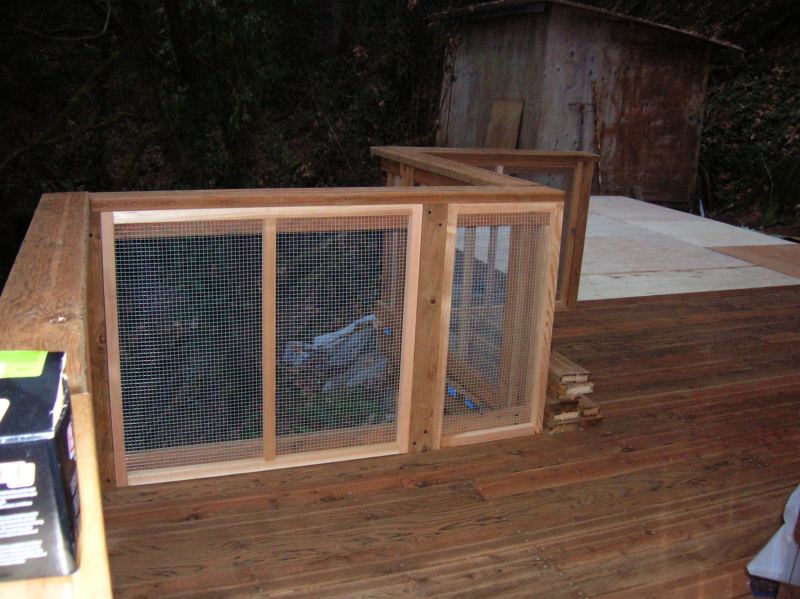 new deck railing with wire mesh panels, and the plywood subfloor down for the office