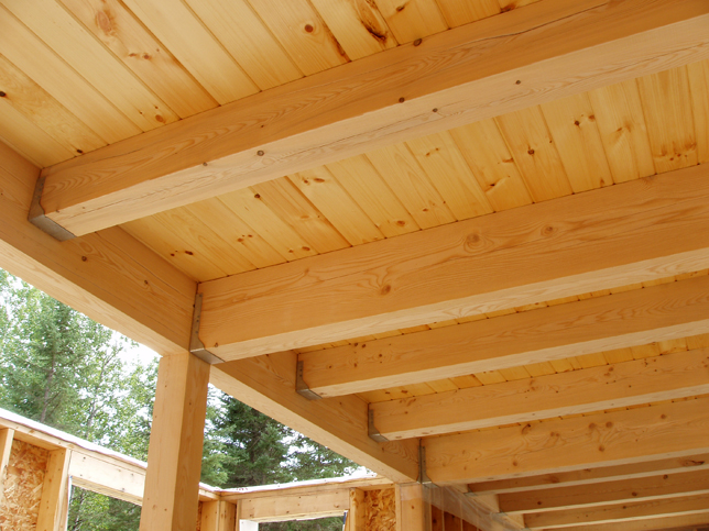 exposed loft beams seen from below the decking
