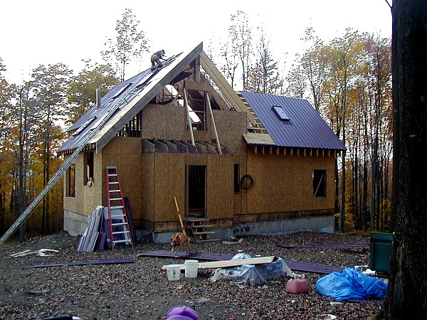 framed house with the single story bedroom addition roofed on the right