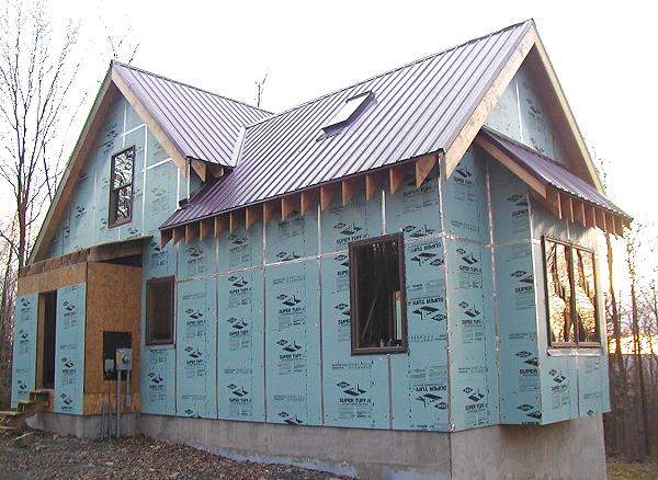 note the pop-out sheds: two shed roofed pop-outs on the rear wall, with the coated basement wall at grade