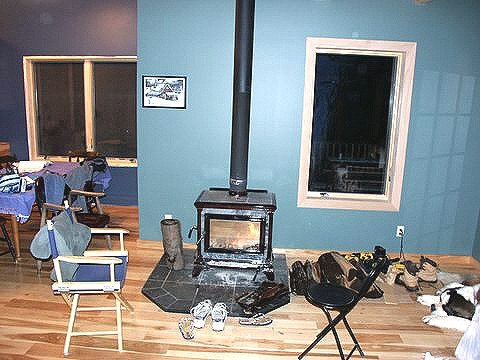 soapstone wood stove on a tile hearth against the living room wall