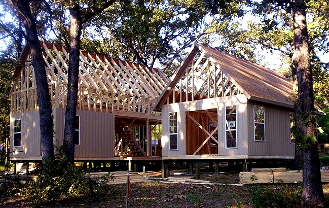 the two cottages at the framing stage with both roofs framed