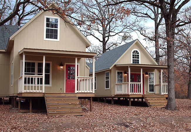 the two finished cottages of the compound side by side among bare winter trees