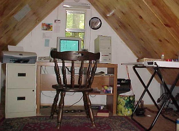 loft office with a ponderosa pine board ceiling and a desk under the window