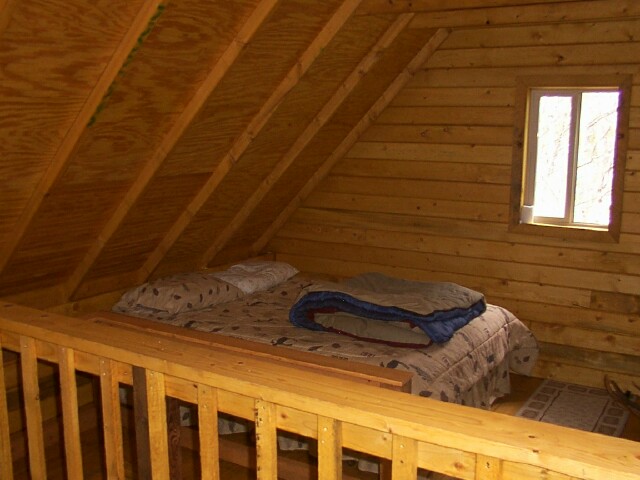 loft bedroom under the steep cabin roof