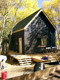 the cabin dried in for the winter among fall aspens