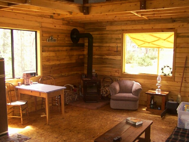 woodstove and living area inside the owner built 14x24 cabin