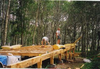 fiberglass insulation going in between the floor joists