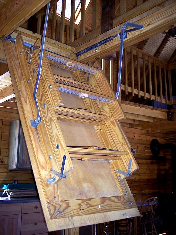 pull down loft ladder swinging down from the loft opening