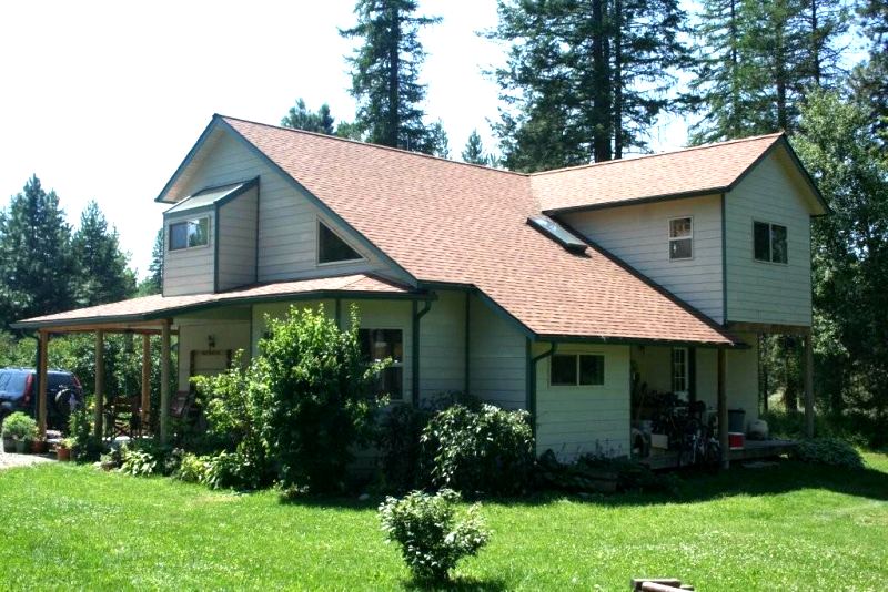 rear of the house with the long saltbox roof slope and a two story addition at the right end