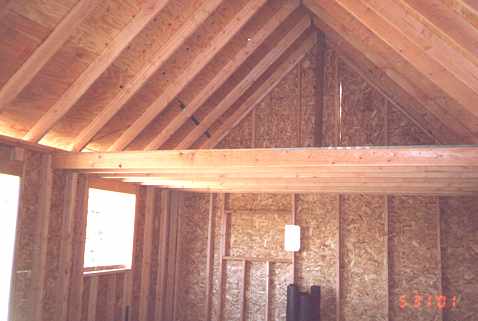 interior framing for the kitchen with the loft floor beam and rafters above
